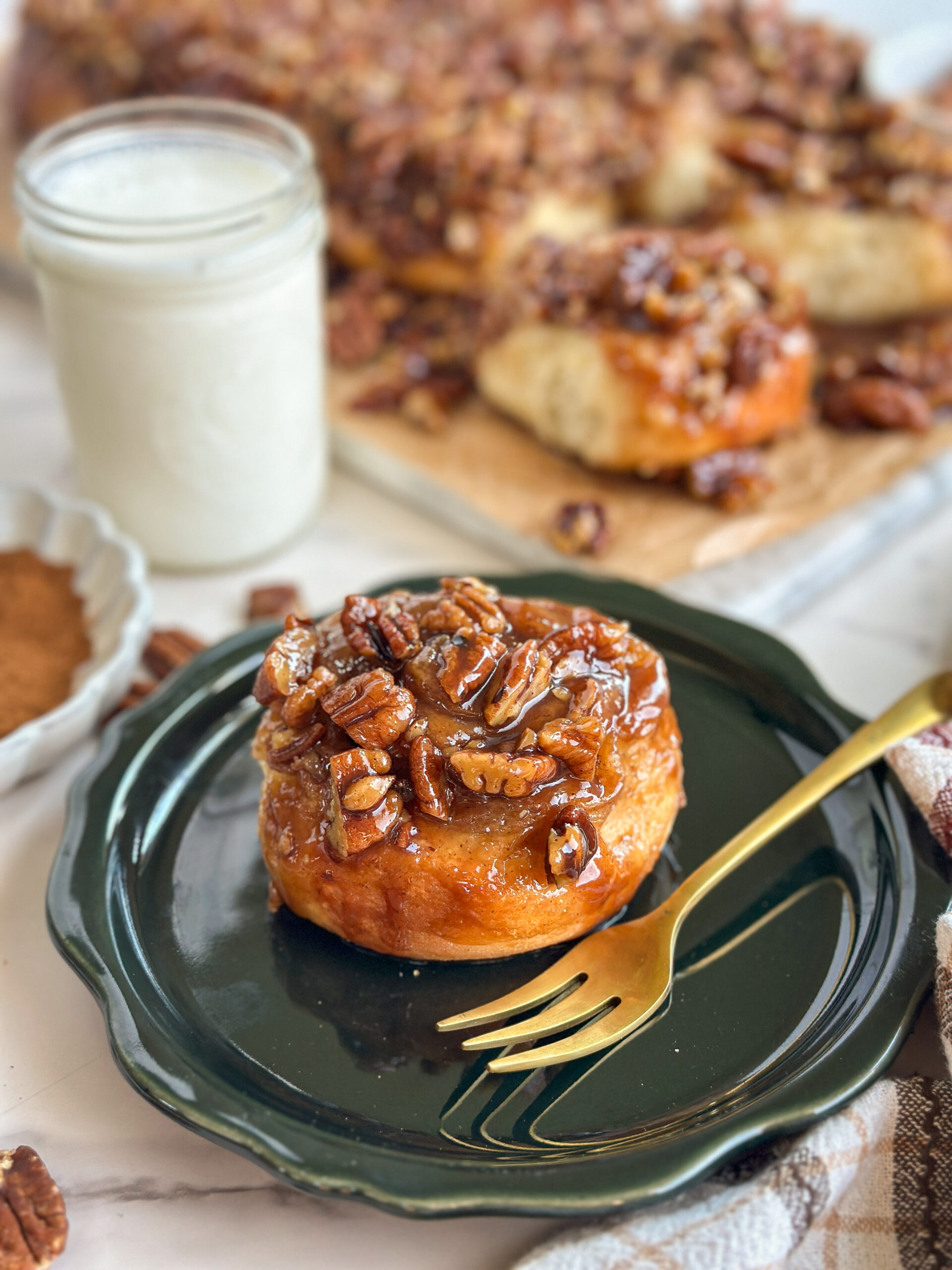 A delicious slice of a maple bun with pecan toppings.