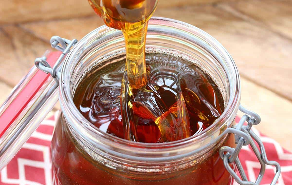 Maple syrup production. Syrup being poured into a container (for about page)